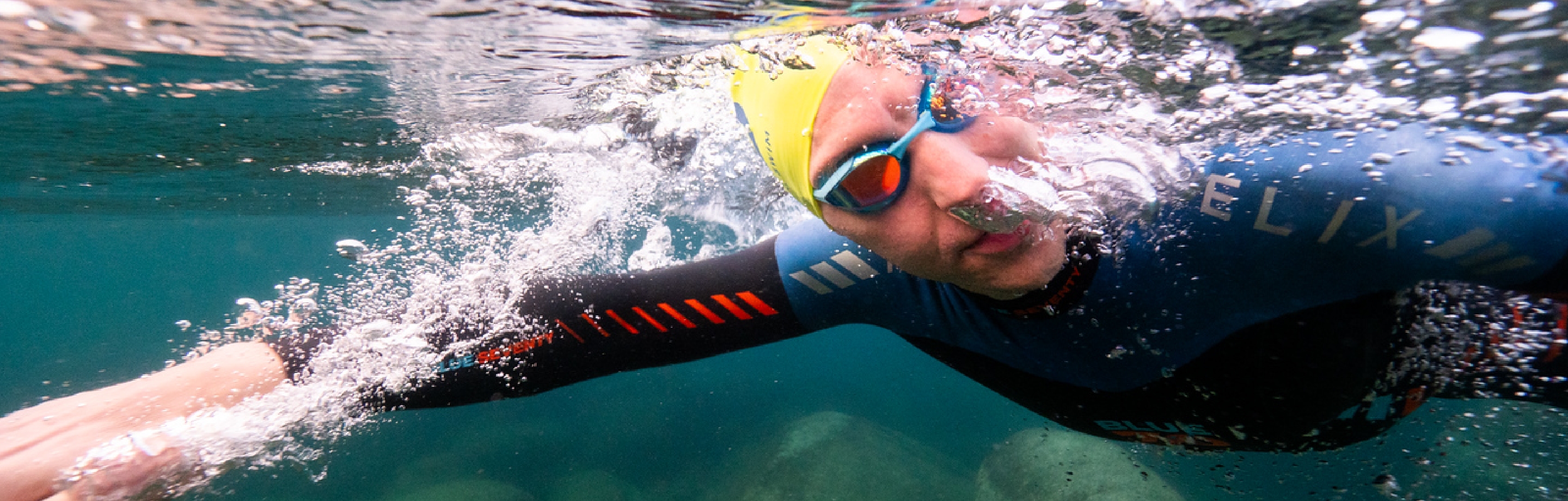 Atleta  nadando llevando puesto un traje de neopreno blueseventy.