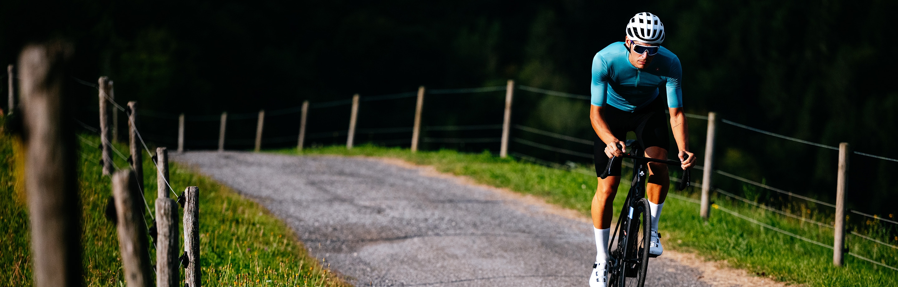 Sportlicher Radfahrer in Castelli Trikot und Bib-Shorts genießt eine Fahrt durch die Natur.
