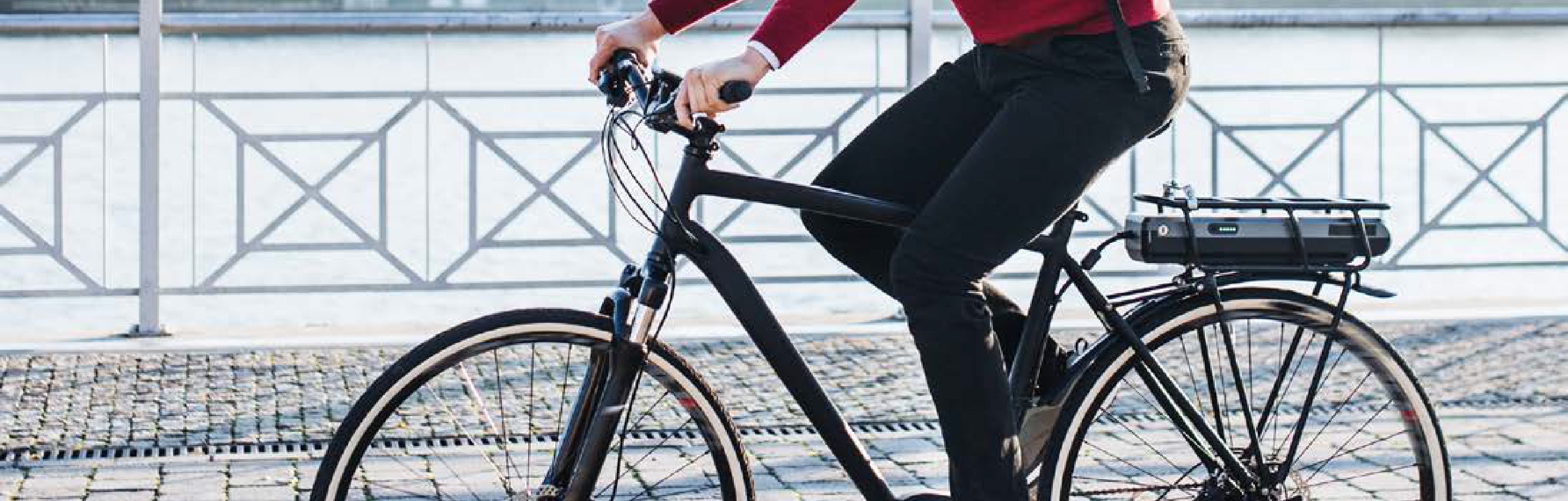 Bicicleta Urbana negra con manillar ergotec en una paseo maritimo y calle empedrada