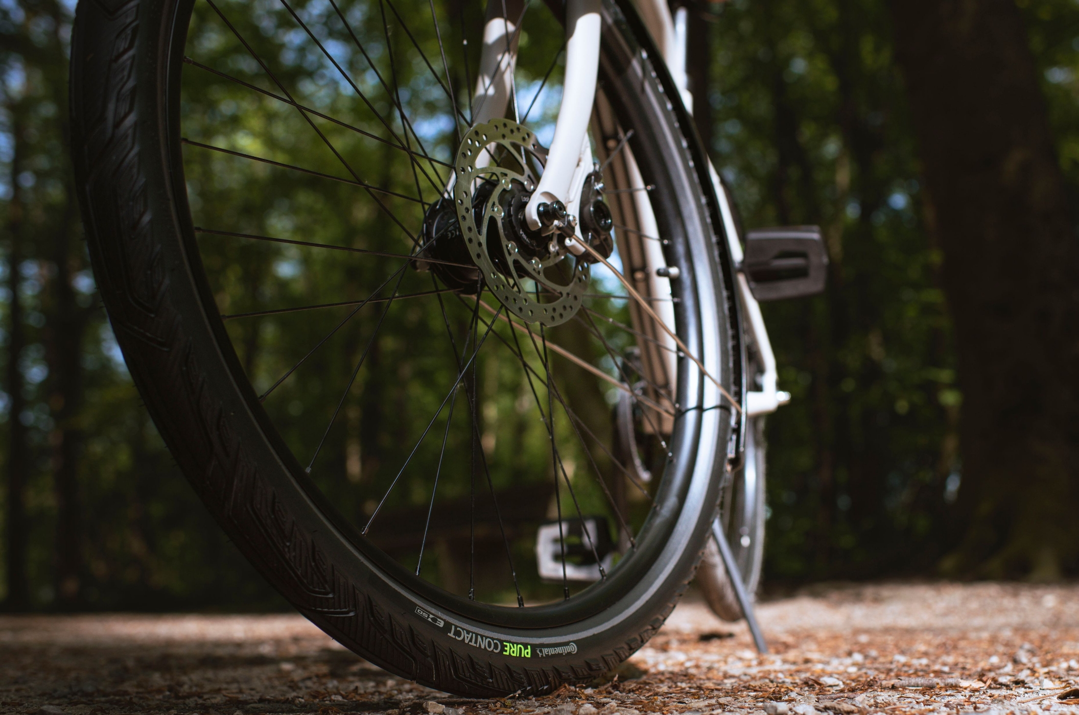 Opony miejskie, trekkingowe i do rowerów elektrycznych: Continental CONTACT – Wszechstronne rozwiązanie do każdego terenu i stylu użytkowania Opona Continental PureContact do codziennej jazdy na twardym leśnym podłożu pod rowerem trekkingowym.