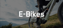 Orbea Bikes – hochwertige E-Bikes Orbea E-Bike-Kategorie Banner, der eine Nahaufnahme eines E-MTBs zeigt, das, an einem Berghang fährt und der Aufschrift E-Bikes