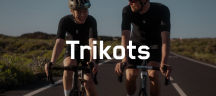 Trikots von FINGERSCROSSED Zwei Personen auf Rennrädern fahren auf dem Asphalt.