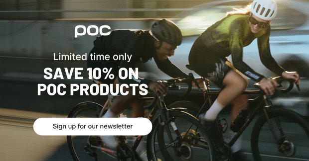 Two cyclists wearing POC Gravel helmets at the start of a ride in an urban setting.