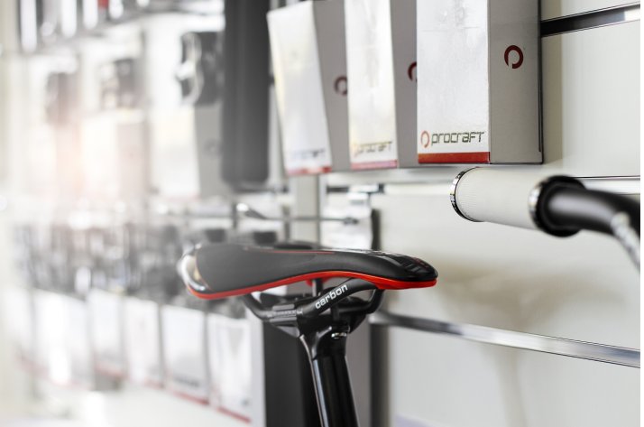 Ein Procraft Sattel samt Sattelstütze vor einer Verkaufswand