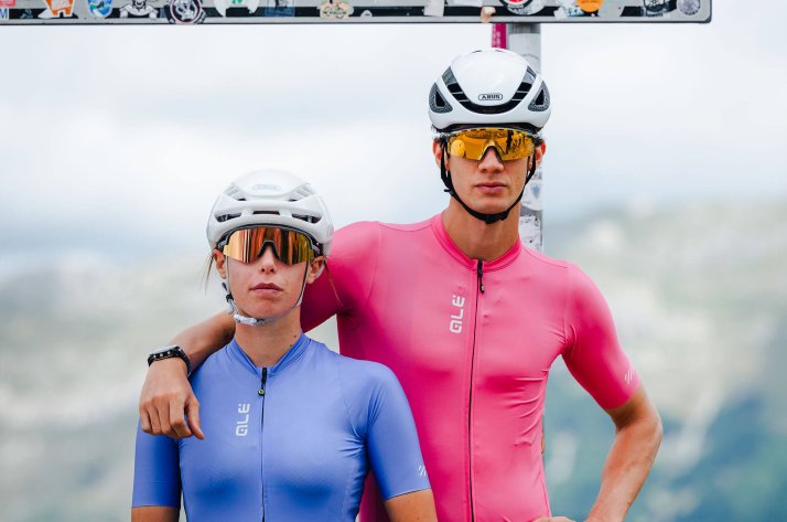 Two cyclists in Alé apparel posing on a mountain road.