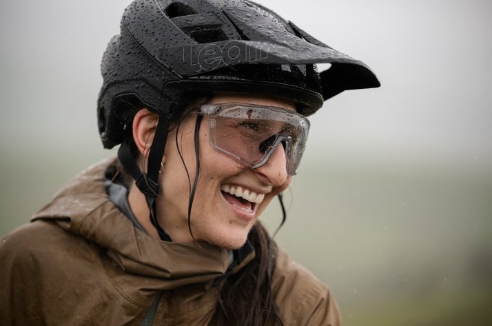 Protections Leatt : protection optimale pour le downhill et le All Mountain Une vététiste souriante porte un casque Leatt mouillé et des lunettes de vélo Leatt