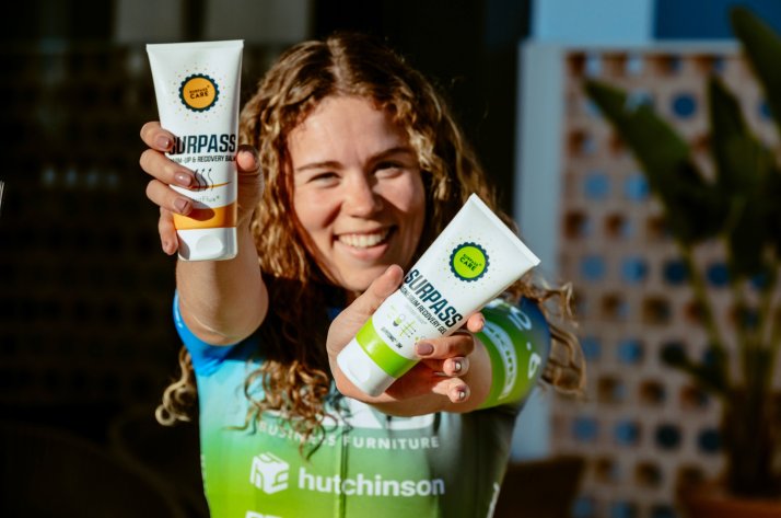Why riders choose SURPASS Cyclist holding SURPASS Warm-Up & Recovery and anti-chafing creams