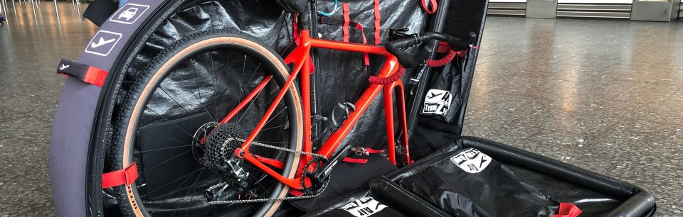 Red bike packed in a TranZbag bike travel bag