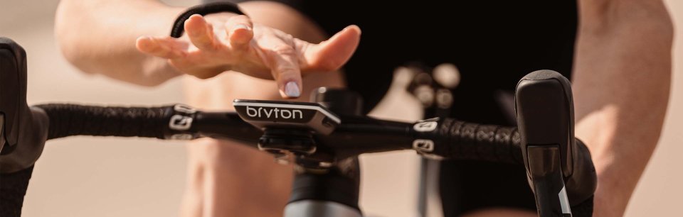 A cyclist using a Bryton bike computer while riding