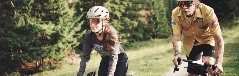 dos personas en una bicicleta con gafas deportivas CHPO en un campo