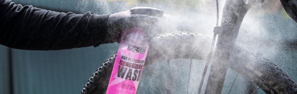 Muc-Off bike cleaner being sprayed onto a mountain bike frame