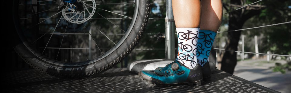 A cyclist wearing Sox Footwear socks.